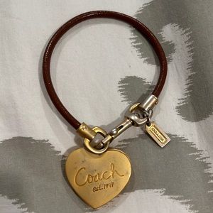Beautiful Coach brown leather bracelet with a gold heart locket!
